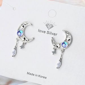 Sterling silver earrings of the moon and the stars with a blue simulated diamond